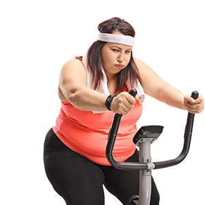 Picture of obese woman trying to workout on the exercise bike